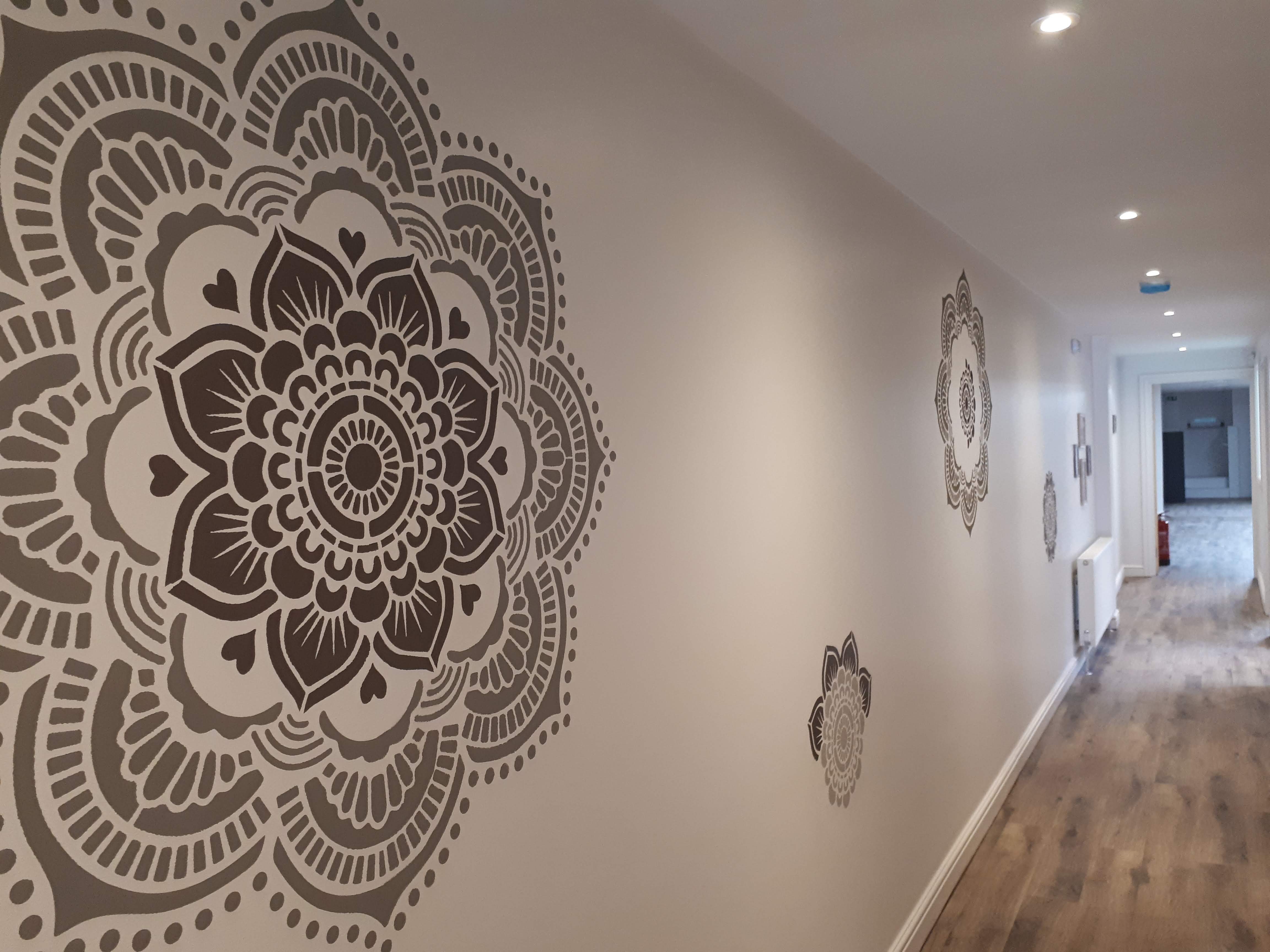 Yoga Rocks studio corridor with mandala art, perfect for networking events and workshops.