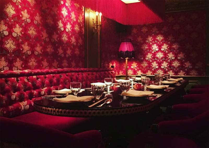 Intimate dining space at Park Chinois, featuring rich red decor for private events.
