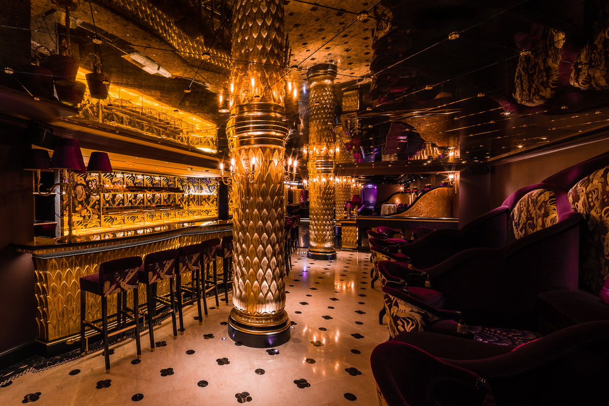 Luxurious event space at Park Chinois with golden decor, ideal for upscale gatherings.