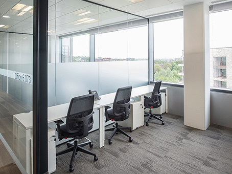 Modern office space with large windows for meetings and collaboration at Spaces Park Royal.