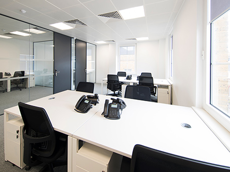 Modern minimalist office space with natural light for productive meetings and collaboration.