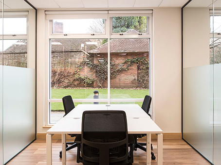 Modern meeting room in Chalfont Park with white table, ideal for collaboration and brainstorming.