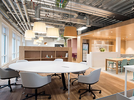 Modern open-concept meeting space with round table for collaboration in Chalfont Park.