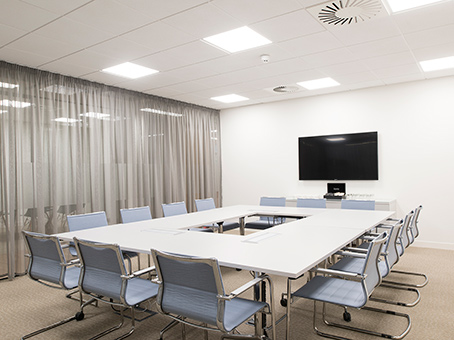 Modern meeting room in Chalfont Park with ergonomic chairs and presentation screen.