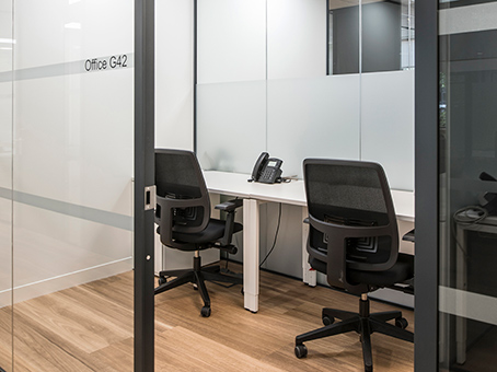 Modern minimalist meeting space with glass walls for focused discussions at Jubilee House.