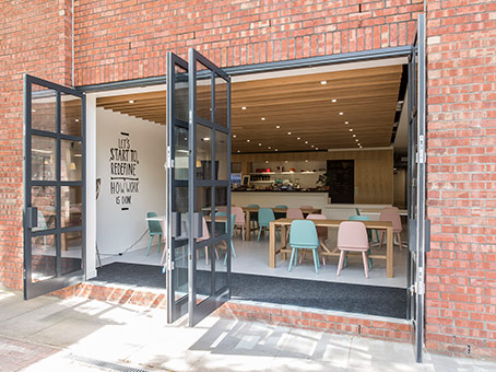 Modern event space with pastel furniture, ideal for networking and workshops.