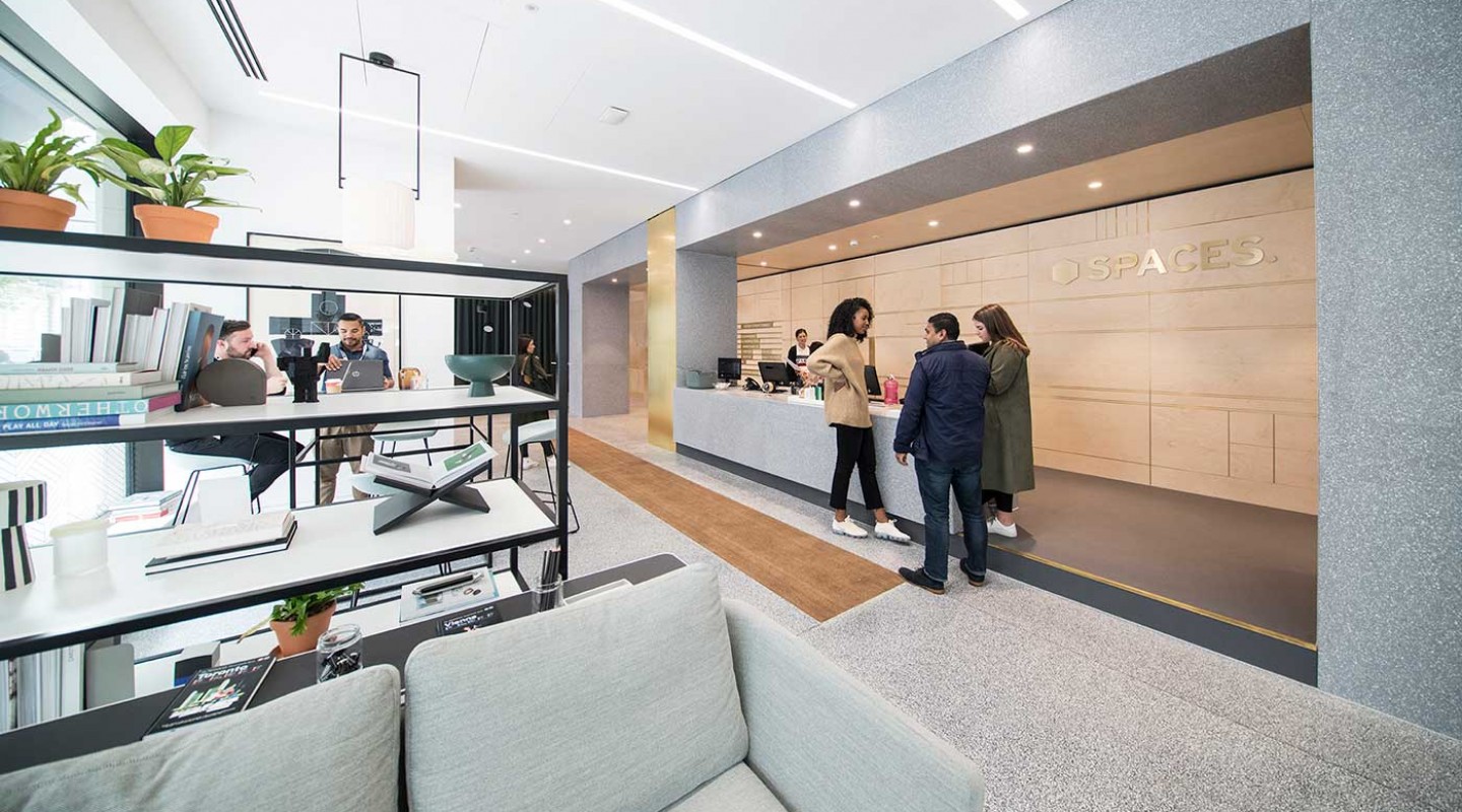 Modern meeting room with sleek front desk, perfect for corporate events and workshops.