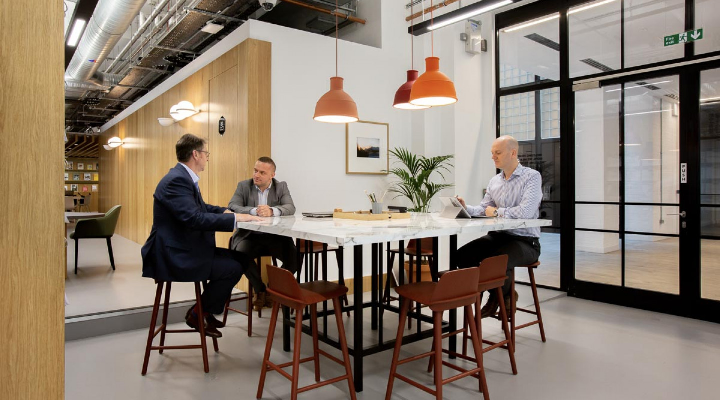Modern meeting room with sleek table, ideal for collaboration and discussions.