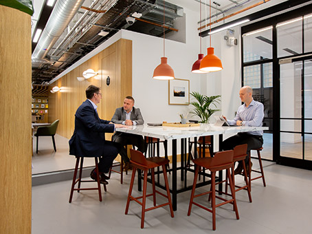 Modern meeting room with sleek table, warm lighting for collaborative discussions.