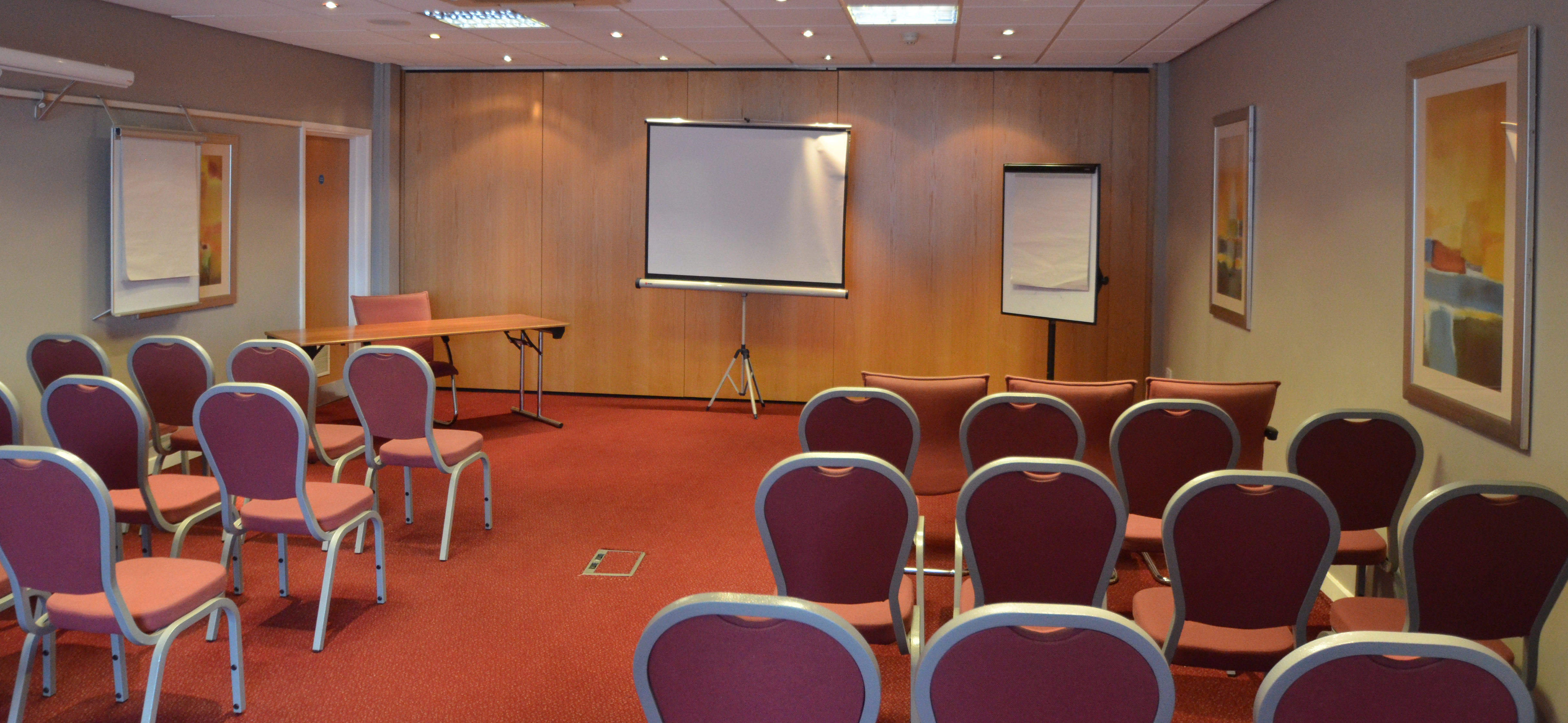 Victoria Suite meeting room with projector, ideal for training sessions and presentations.