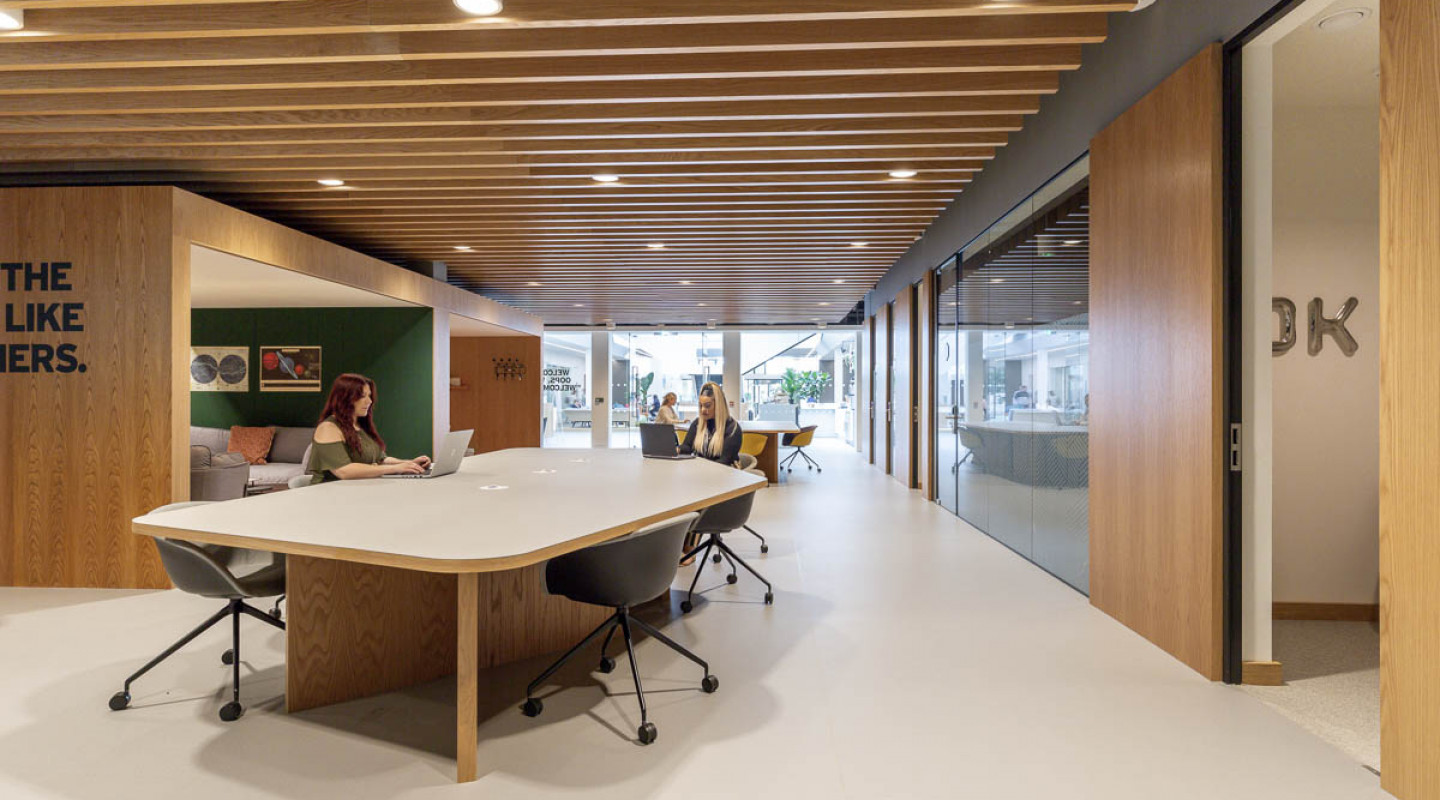 Modern meeting space at Heathrow Airport with sleek furniture for team collaboration.