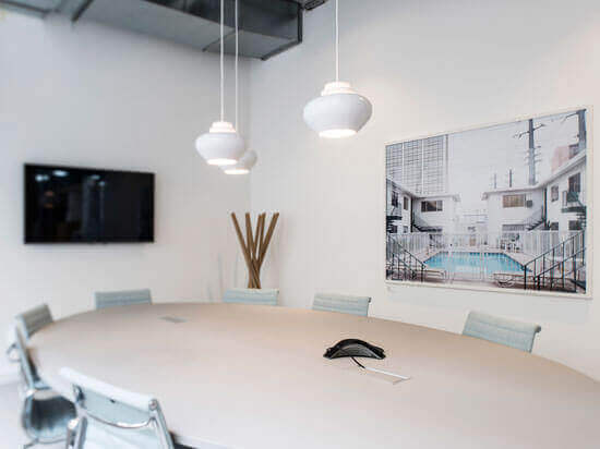 Modern conference room with oval table for meetings at Spaces Oxford Circus.