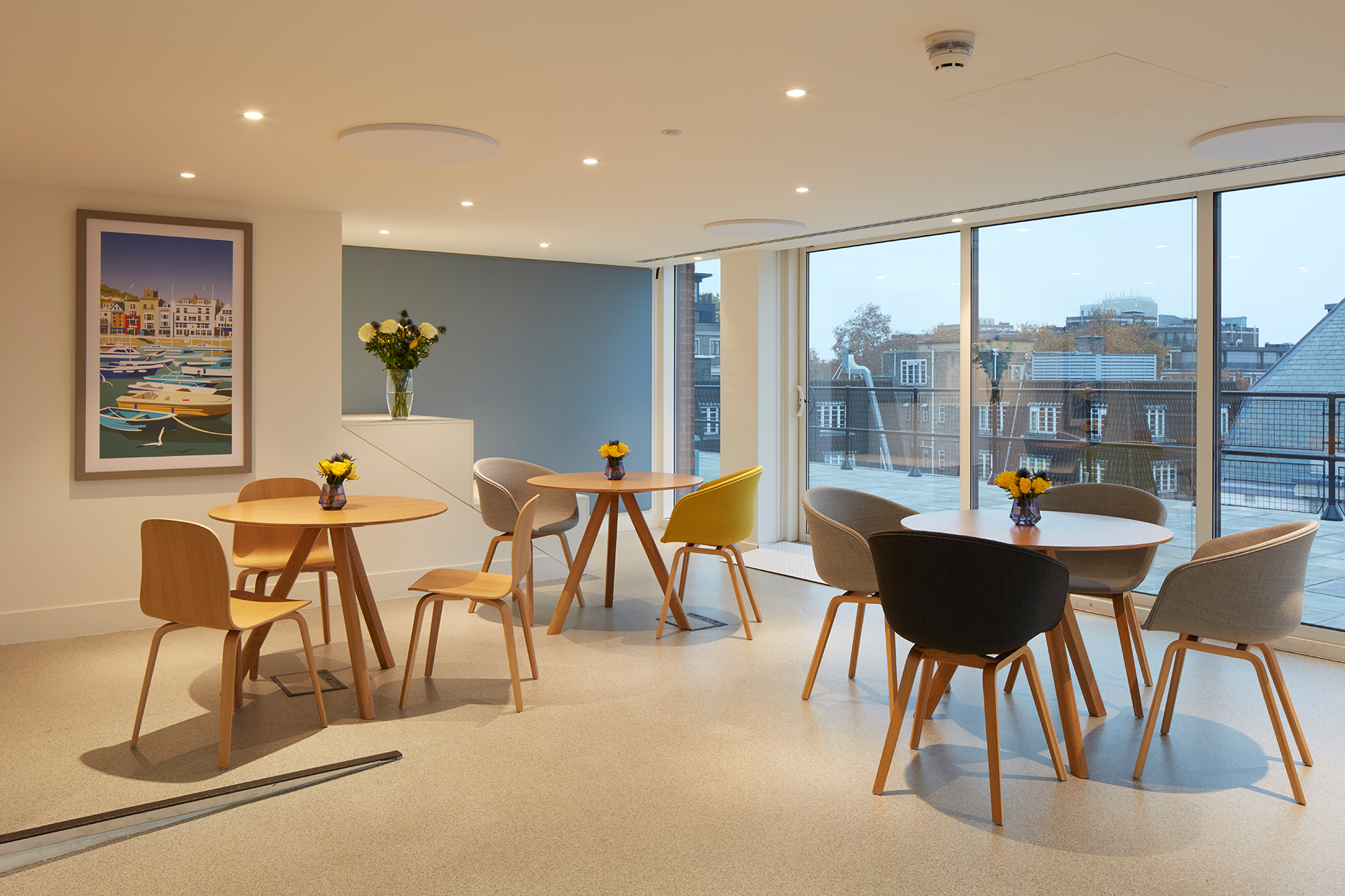 Modern meeting space at Open Council, featuring stylish round tables for collaboration.