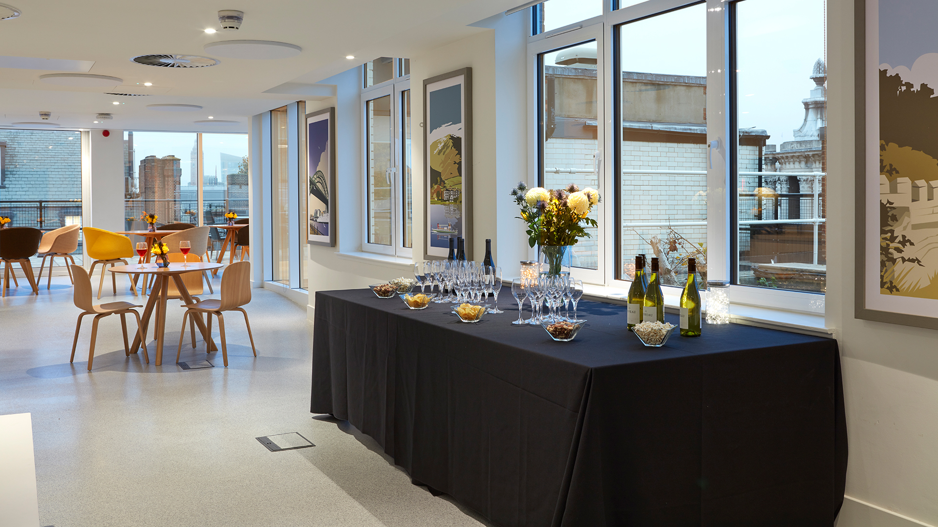 Open Council event space with sleek black table, ideal for receptions and networking.
