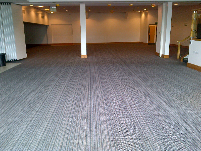 Spacious event venue with oak trees, ideal for conferences and social gatherings.