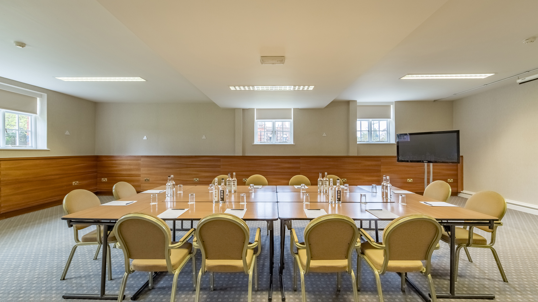 Meeting room at The Elvetham, Hampshire with large table, ideal for workshops and presentations.