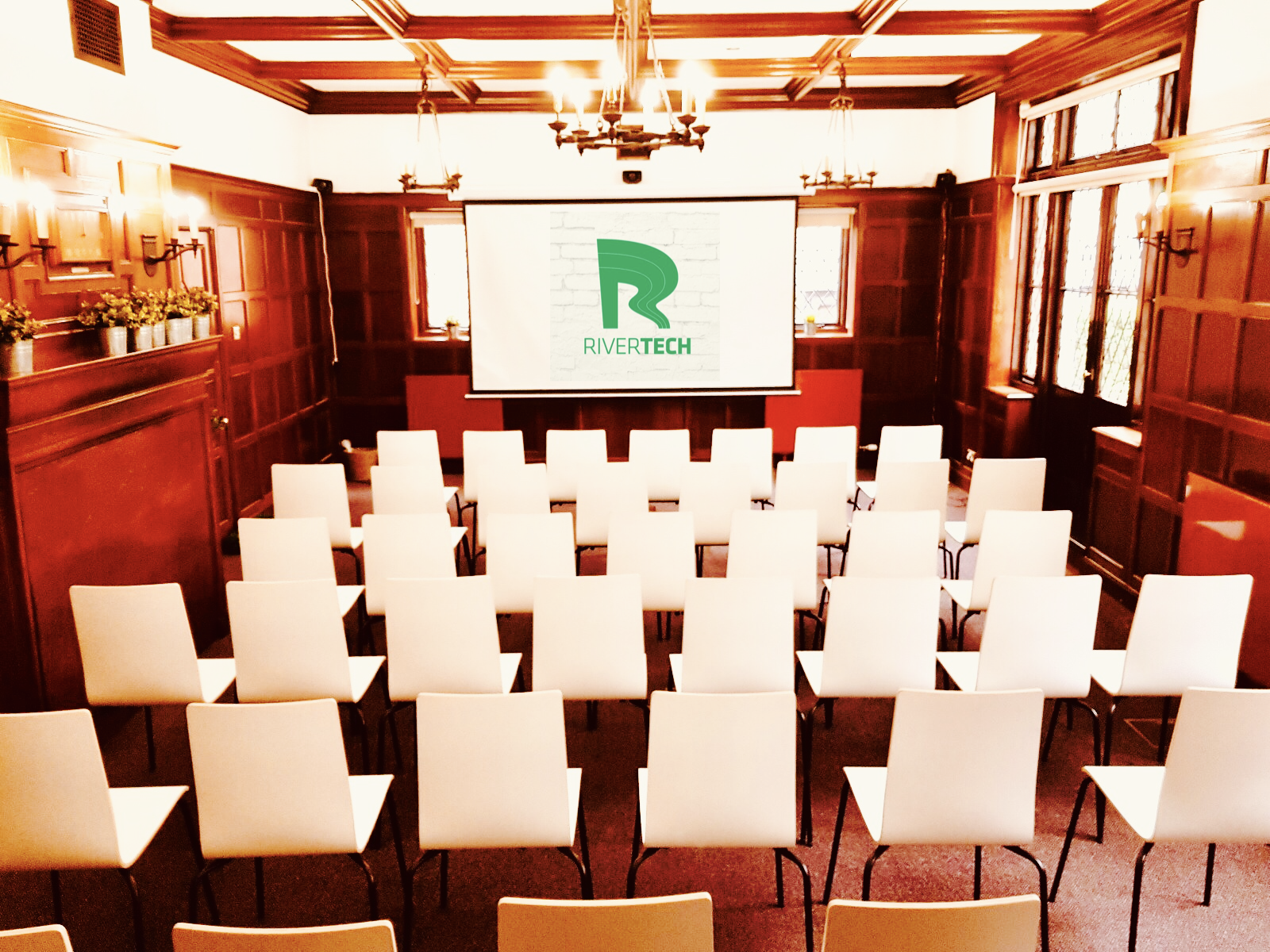 William Penn corporate event with white chairs and warm wood paneling in Rivertech.
