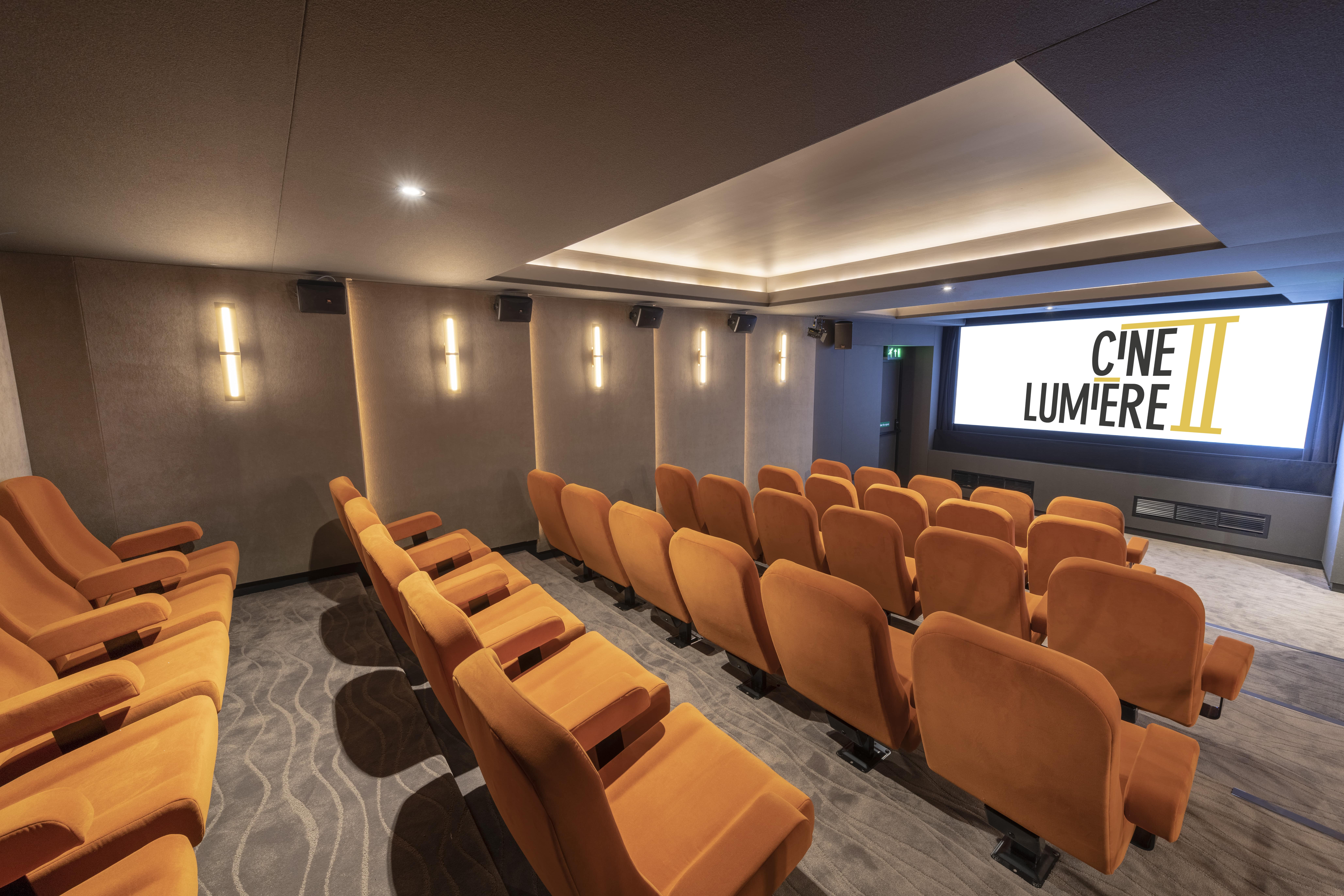 Ciné Lumière 2: modern screening room with plush seating for events and presentations.