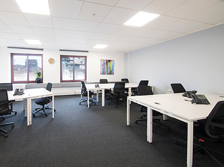 Modern meeting space at Baltic Wharf, featuring desks and natural light for workshops.