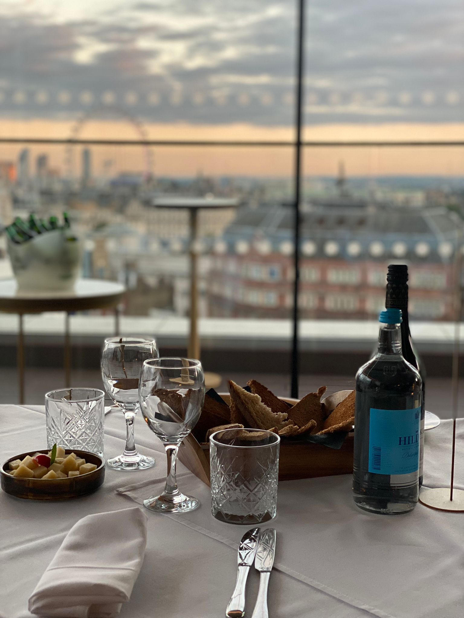 Sophisticated rooftop dining setup with skyline view, perfect for upscale events and networking.