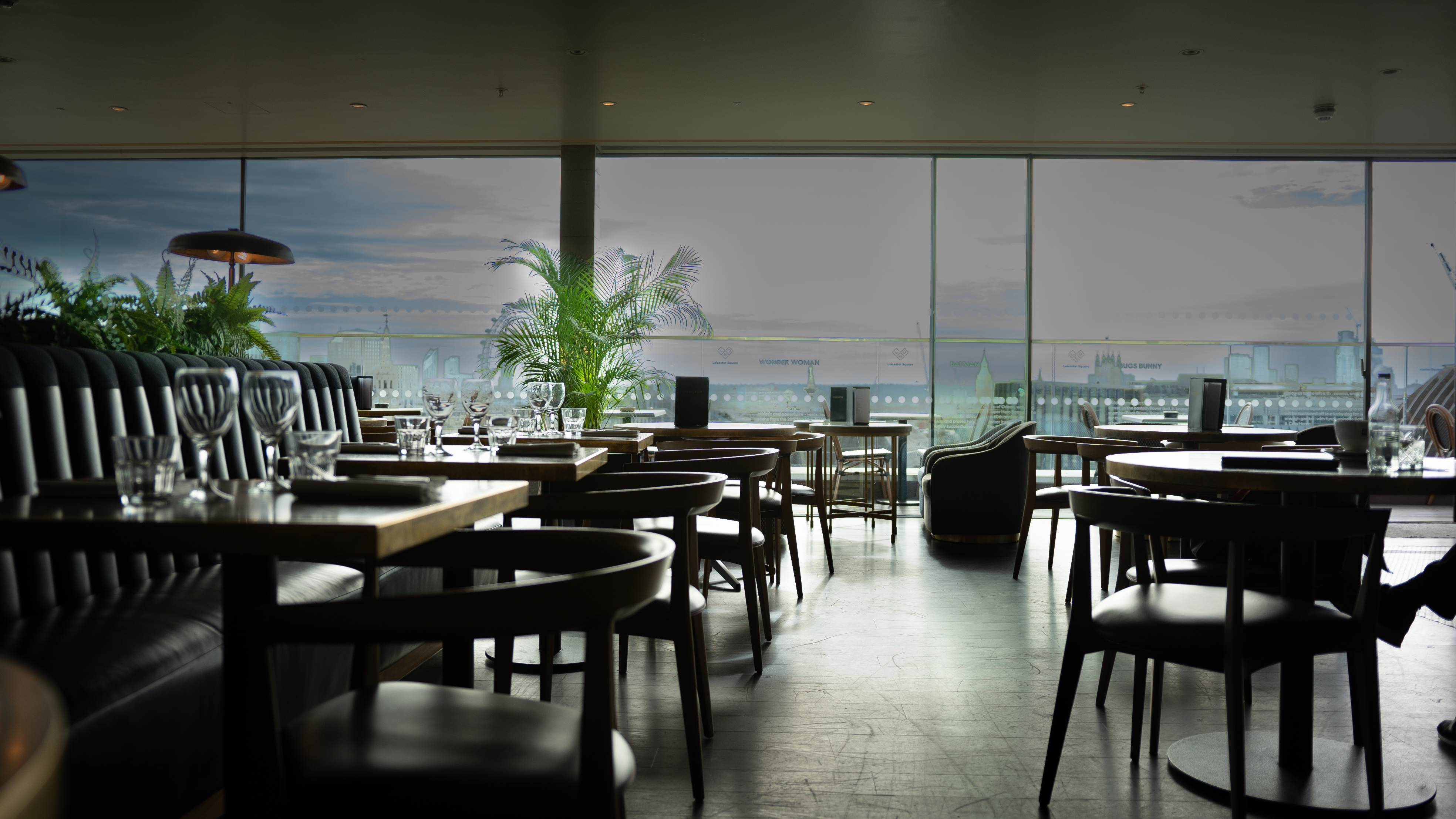 Modern LSQRooftop venue with large windows, perfect for intimate meetings and events.