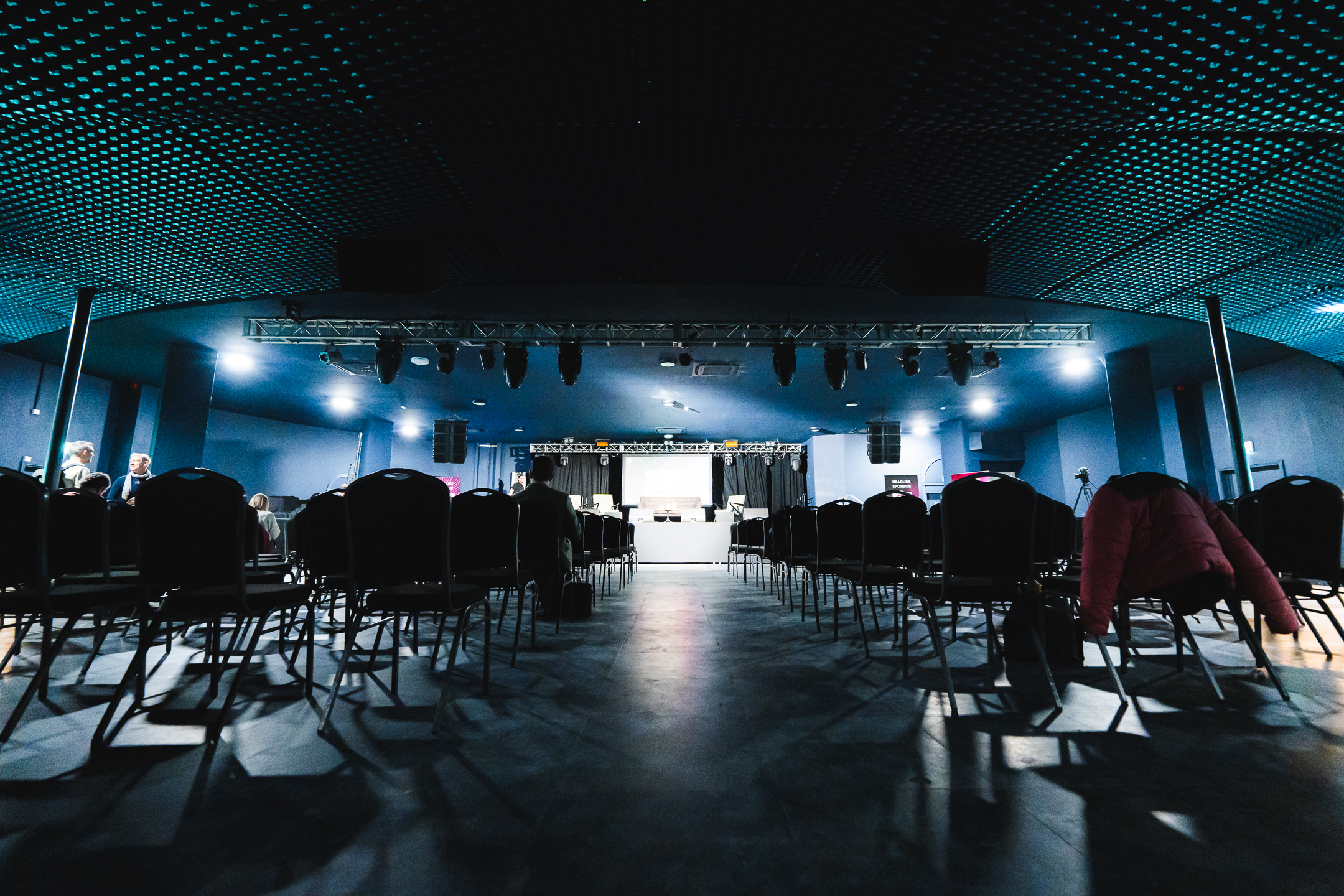Spacious Concert Hall venue with empty chairs, ready for a presentation event.