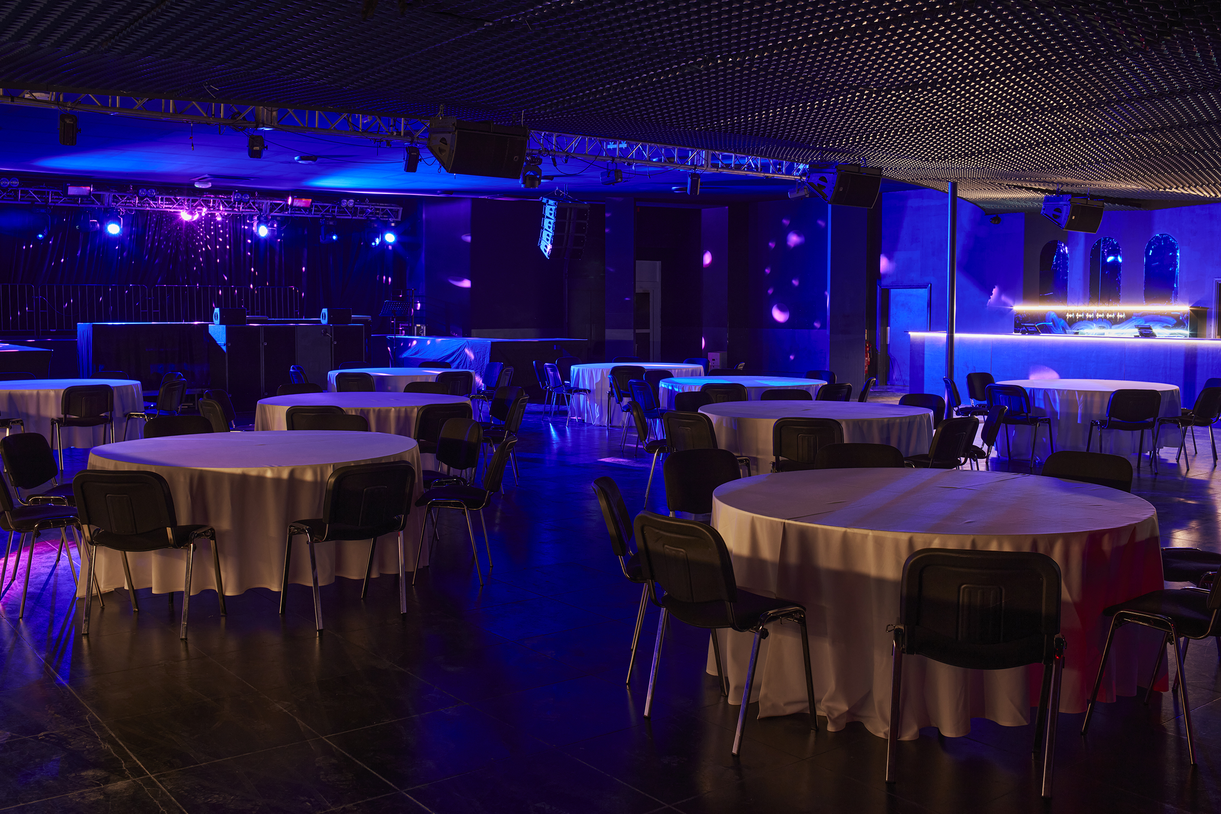 Versatile Concert Hall in EartH with round tables for dining and networking events.