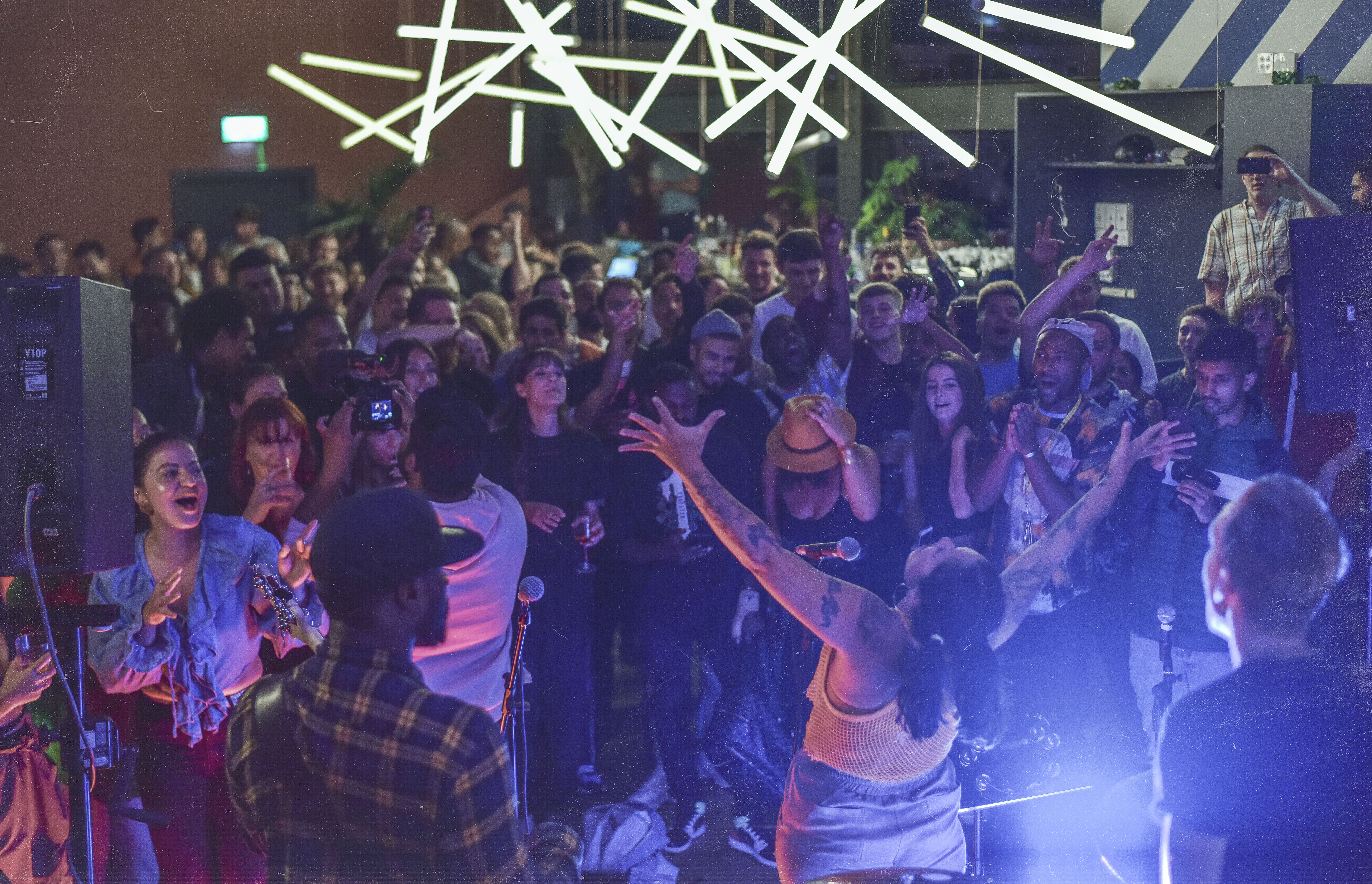 Vibrant live event at Bar + Kitchen, EartH with dynamic lighting and engaged audience.