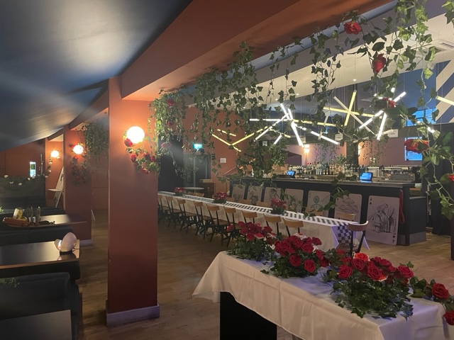 Stylish event space at Bar + Kitchen, modern decor with lush greenery for gatherings.