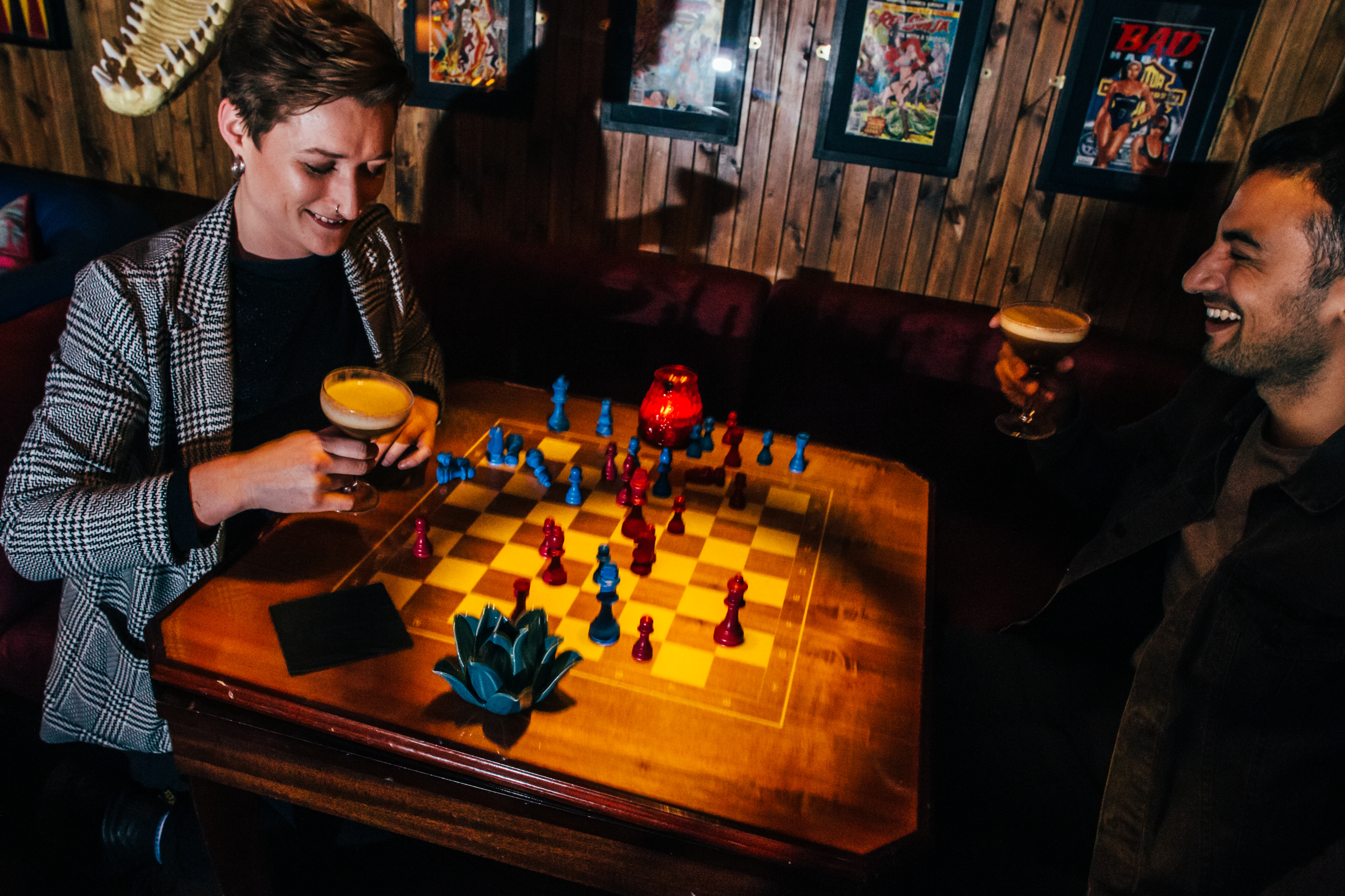 Flatmates Den chess game in vibrant social setting for networking events.