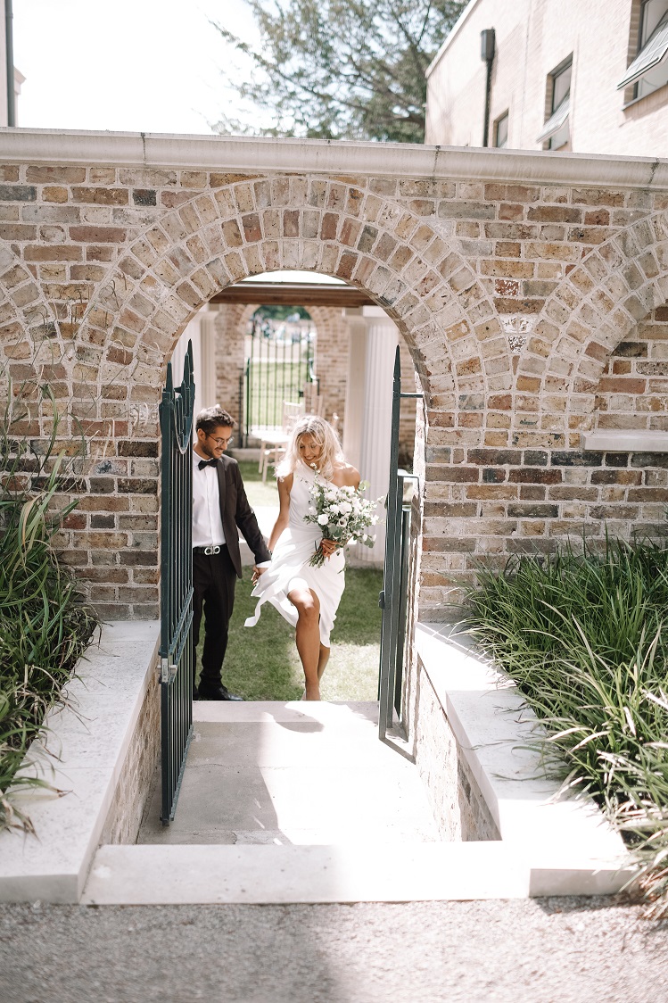 Joyful couple exiting The Colonnade at Pitzhanger Manor, perfect for weddings and events.