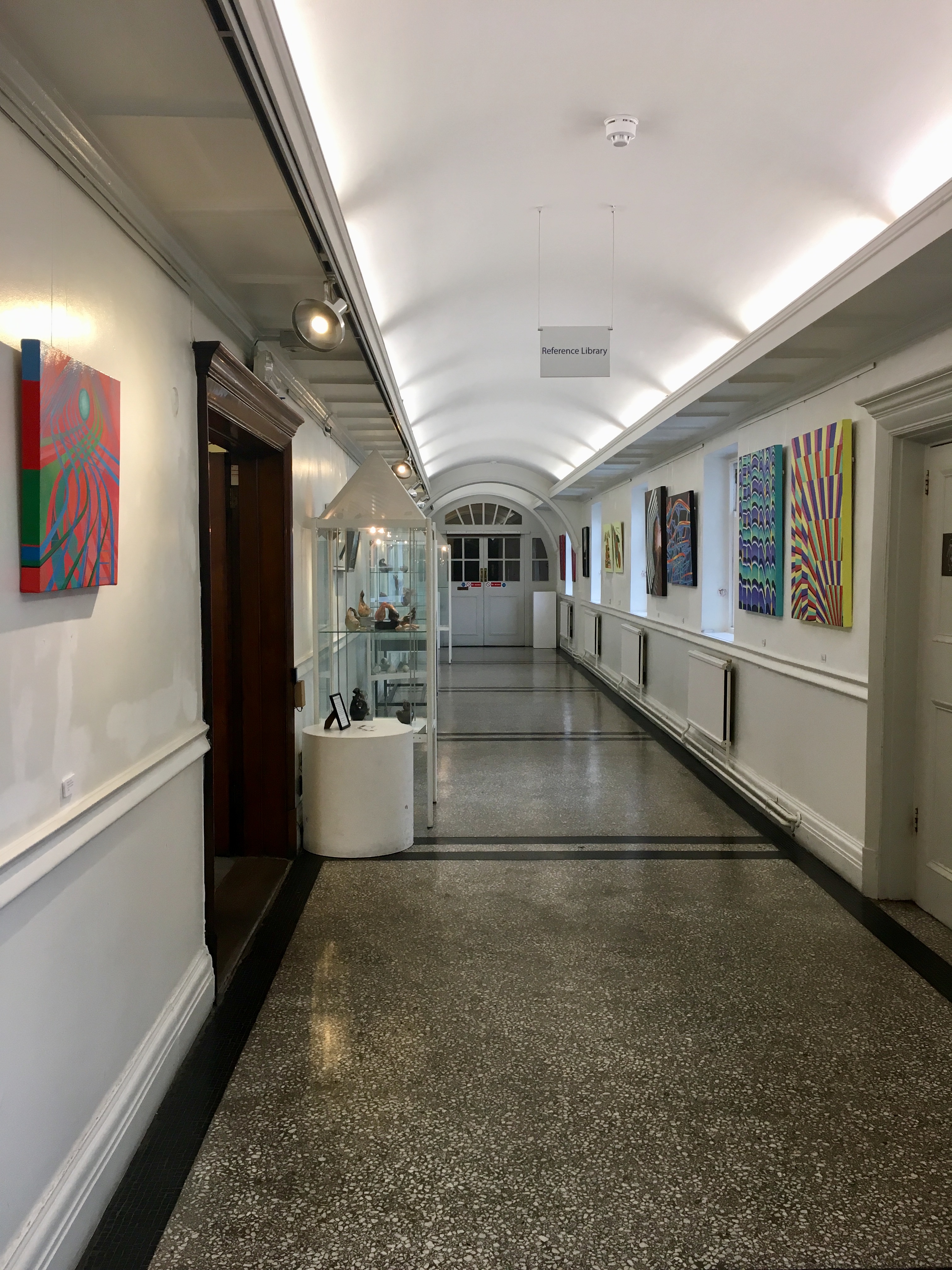 Chelsea Gallery corridor with vibrant artwork, ideal for networking events and art exhibitions.