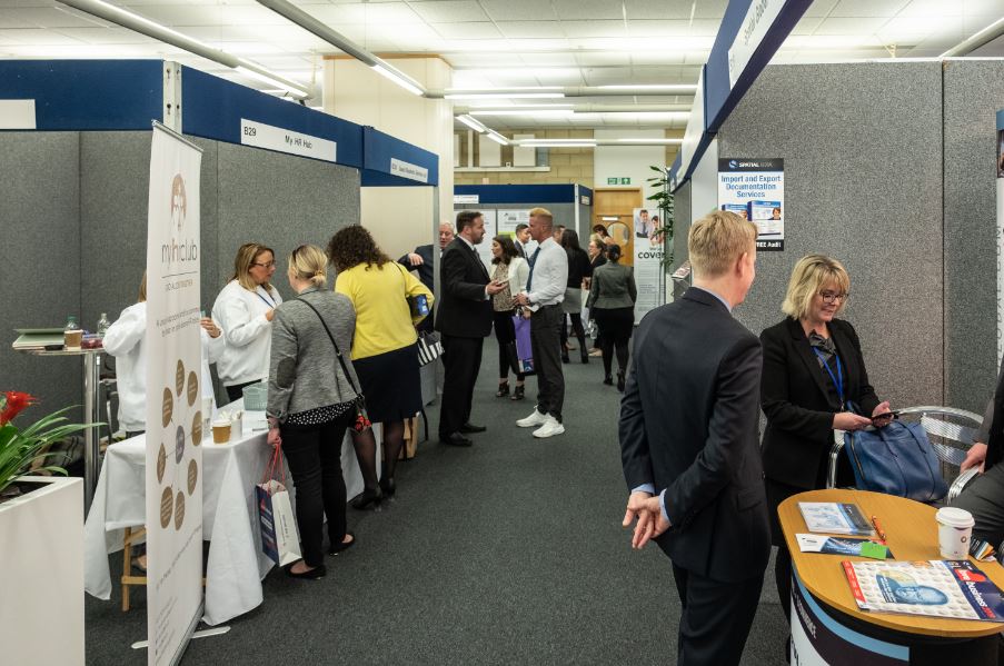 Babbage exhibition space with attendees networking at Holywell Park Conference Centre.