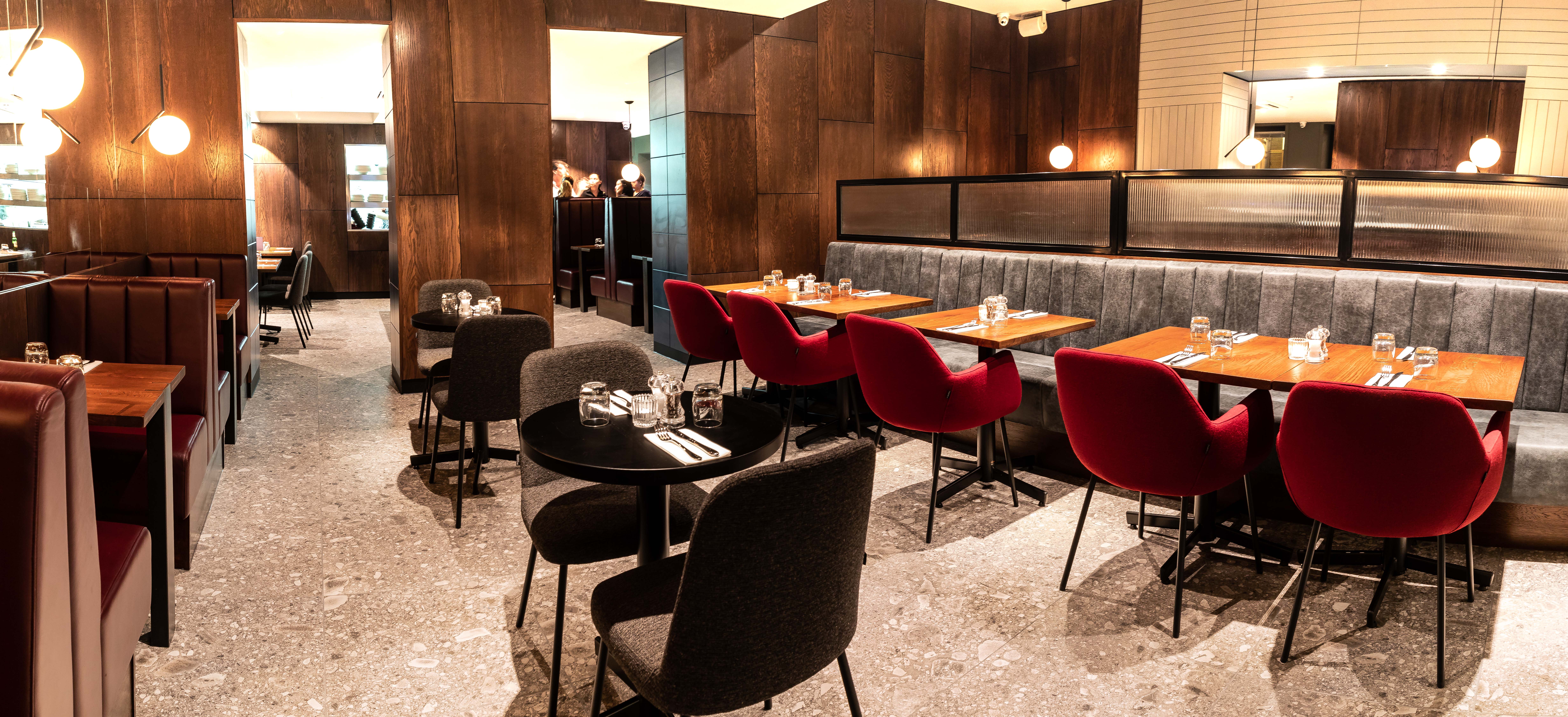 Modern private dining room with plush seating for intimate meetings and events.