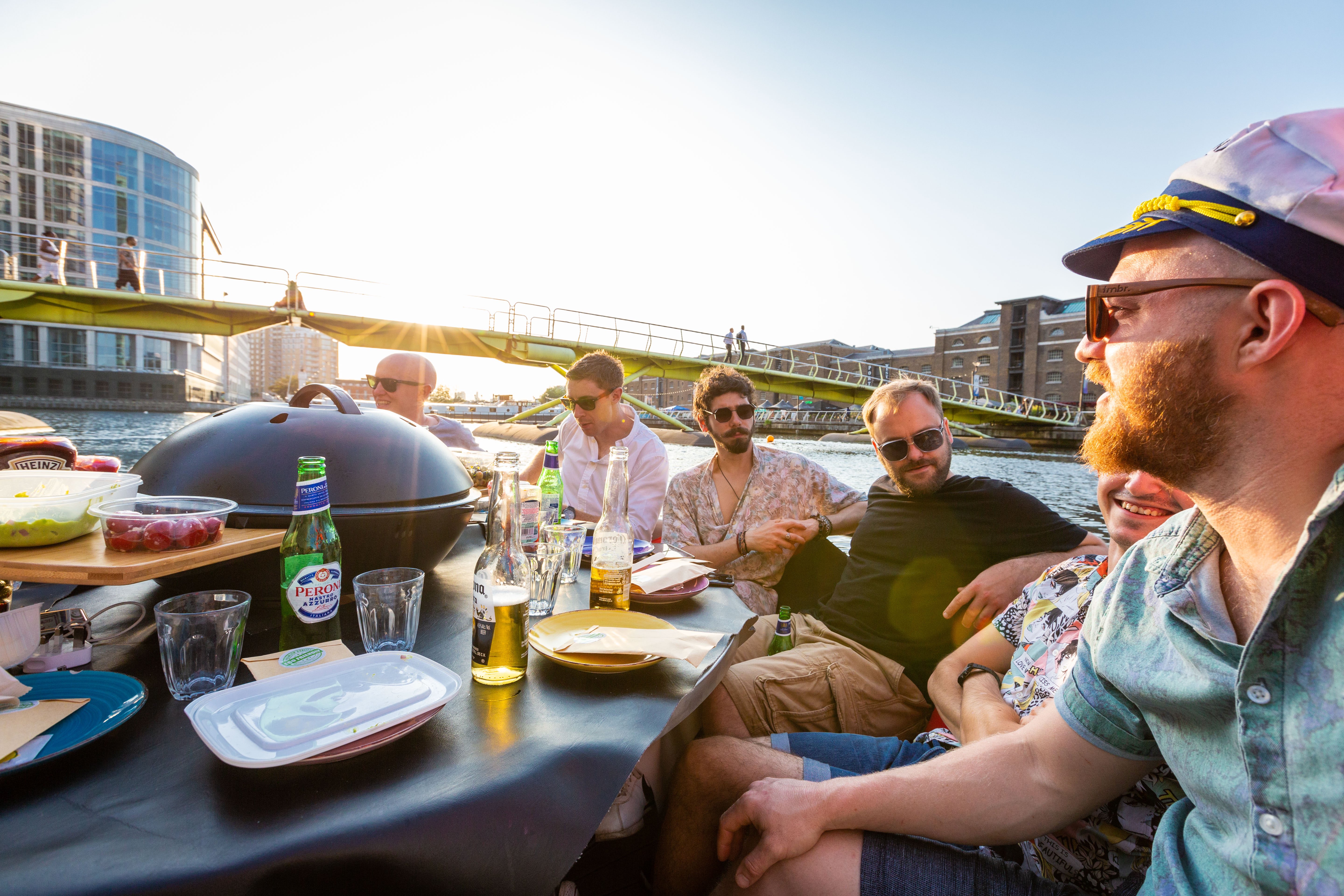 BBQ boat gathering with food and drinks, ideal for team-building events.