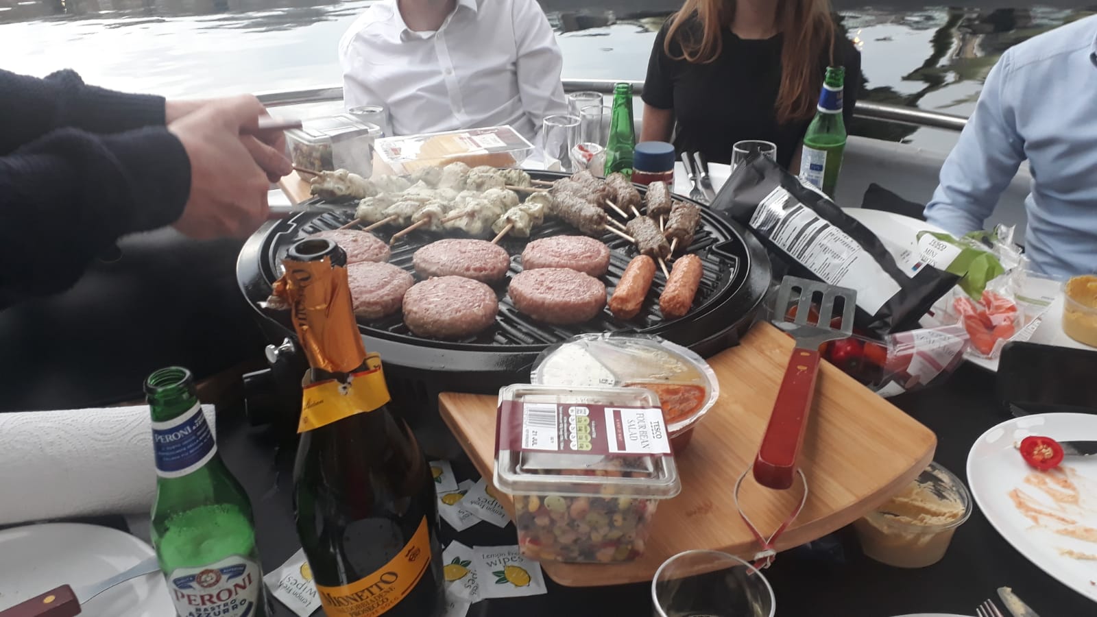 BBQ Boat with barbecue setup, ideal for corporate events and team-building gatherings.