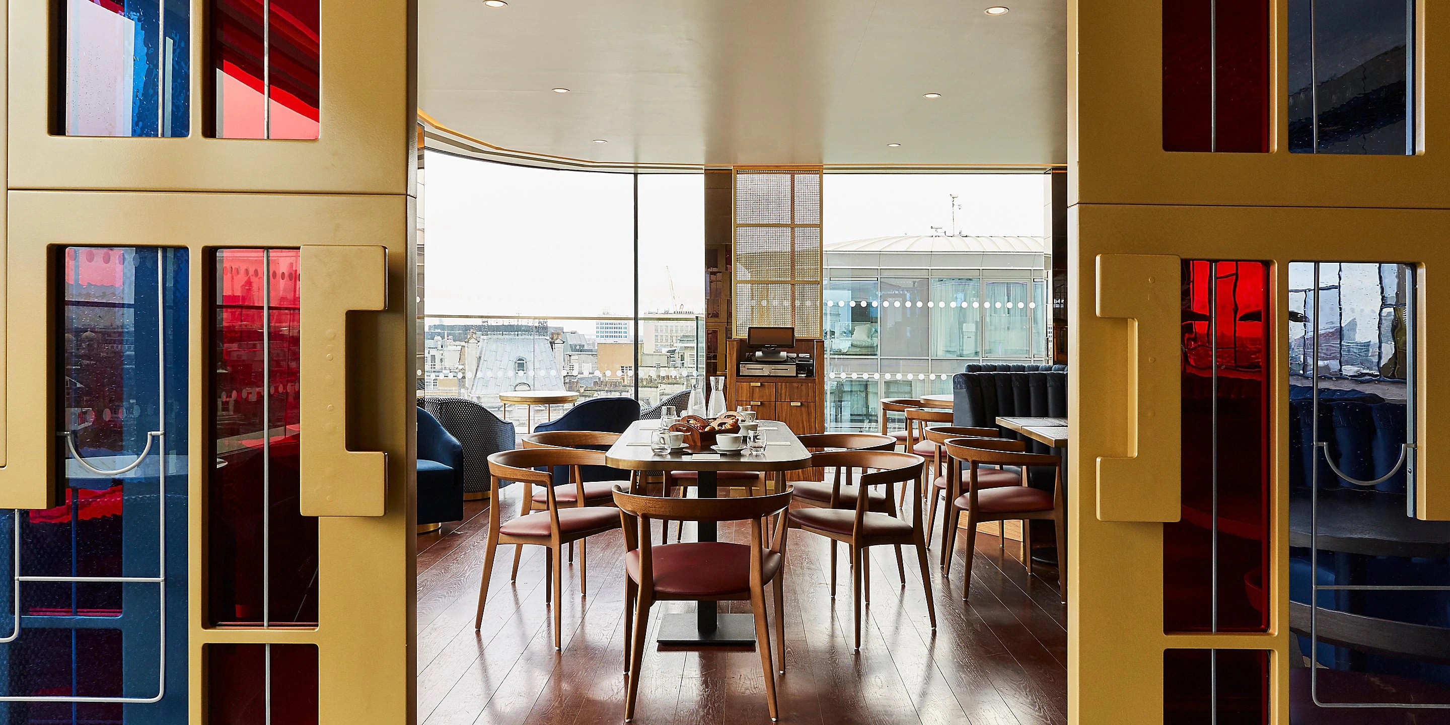 Stylish meeting space with round table and scenic views at The View @LSQ rooftop.