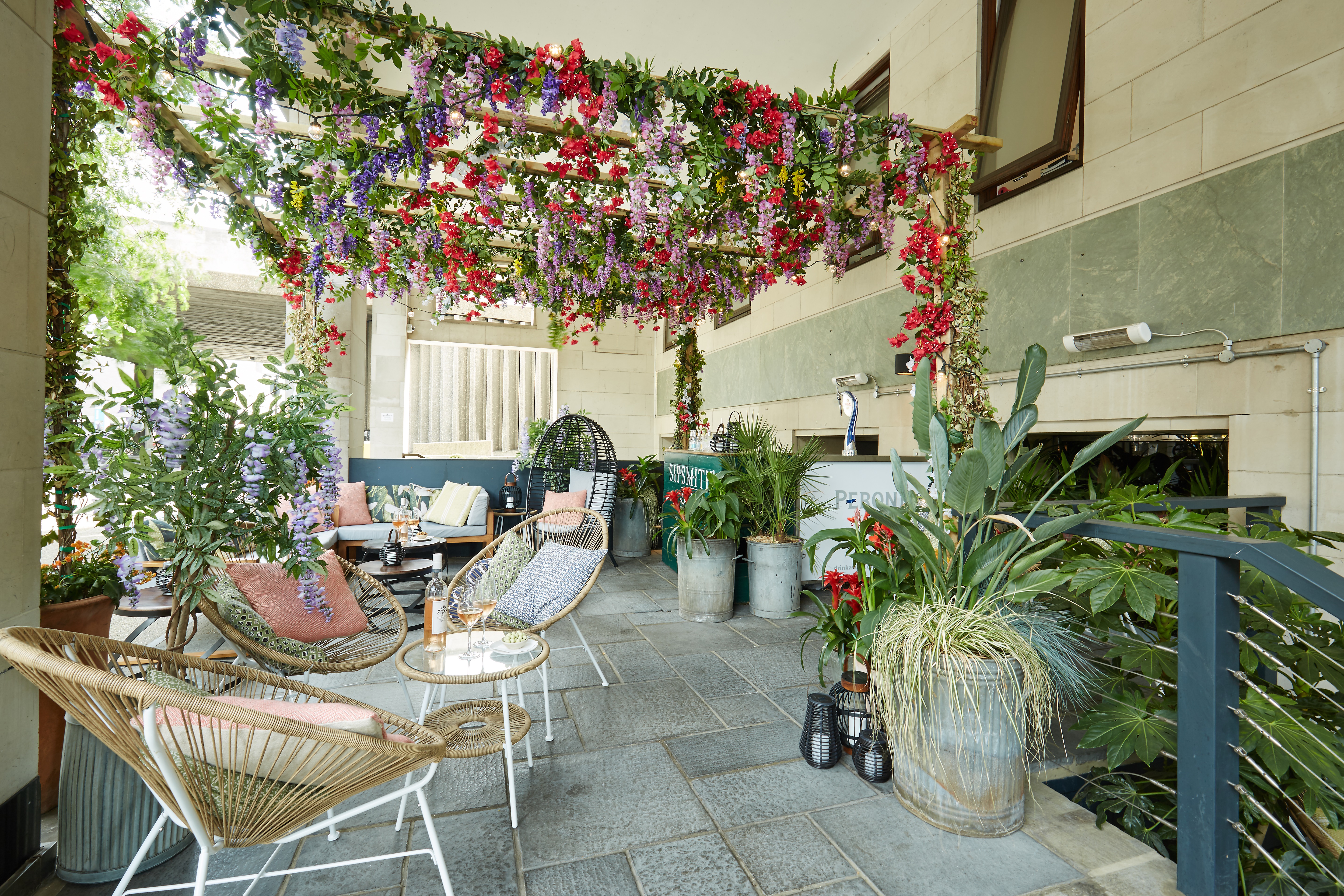 Outdoor event space at Brasserie Blanc Southbank with lush greenery and floral decor.