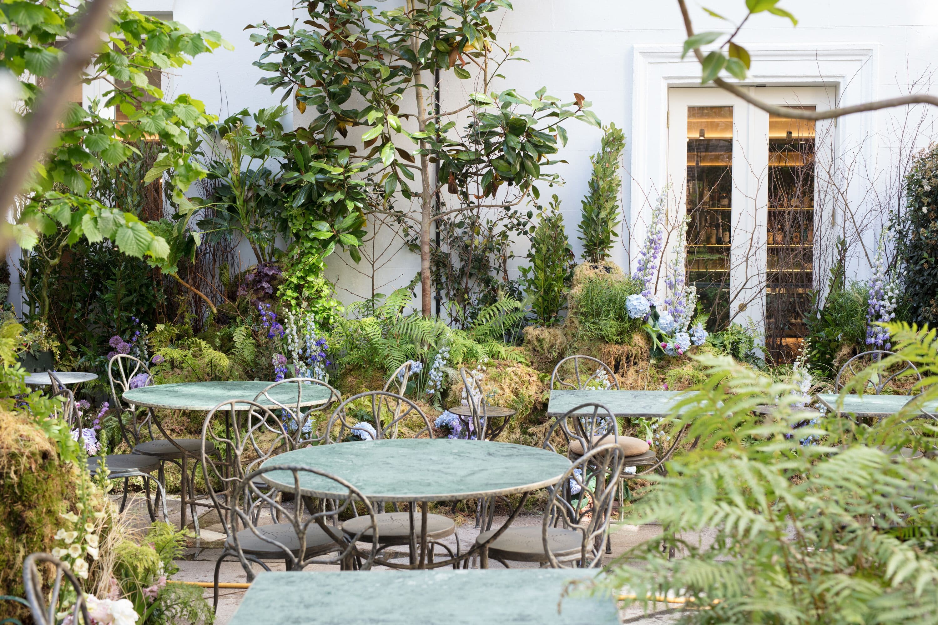 Outdoor venue at Petersham Nurseries, featuring lush greenery for events and gatherings.
