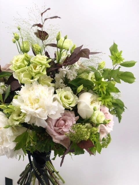 Floral centerpiece in soft pastels at Petersham Nurseries for elegant events.
