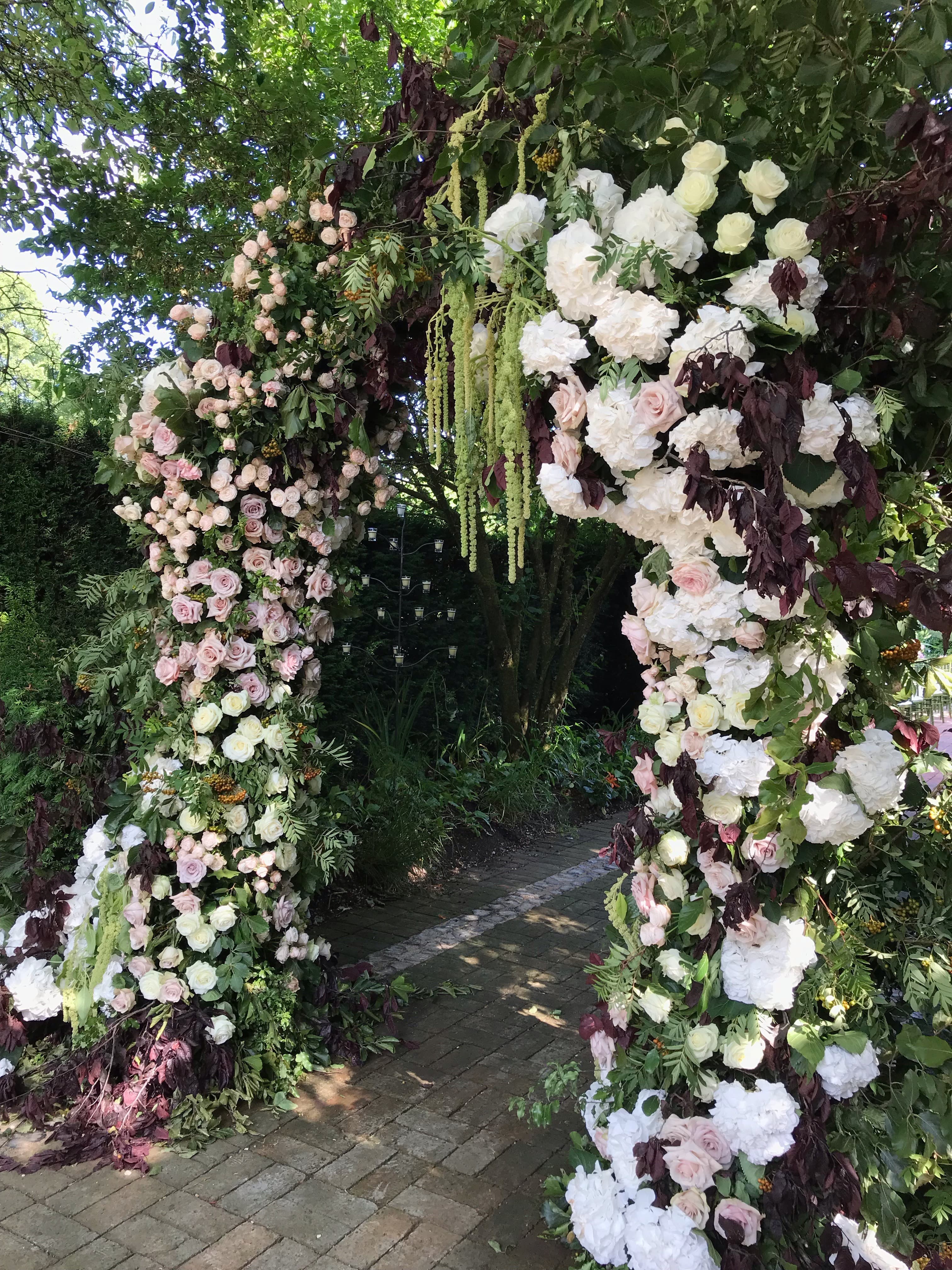 Floral archway at La Goccia, perfect for weddings and garden parties in Covent Garden.