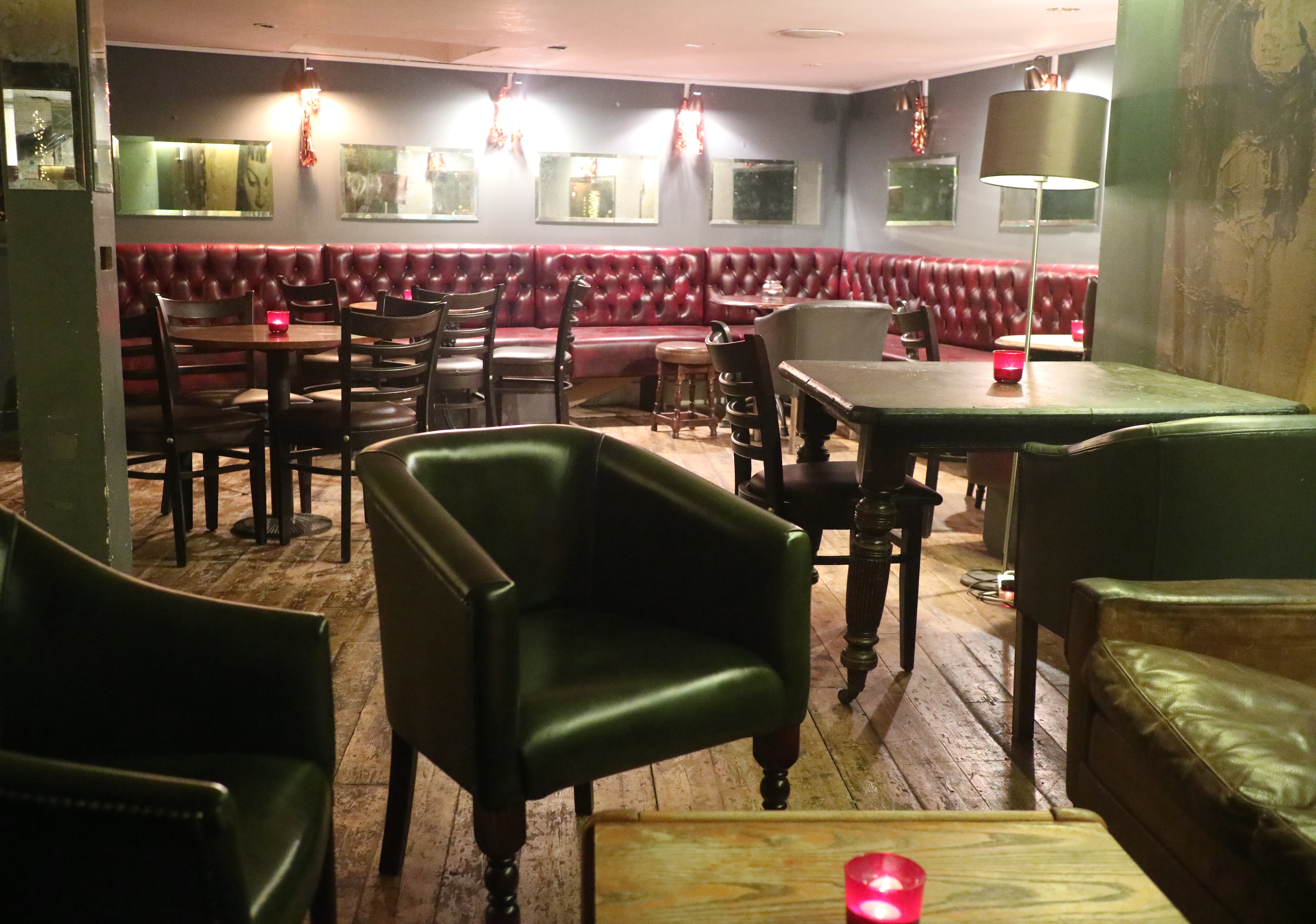 Cozy basement venue with plush seating for intimate networking events at The Regent Pub.