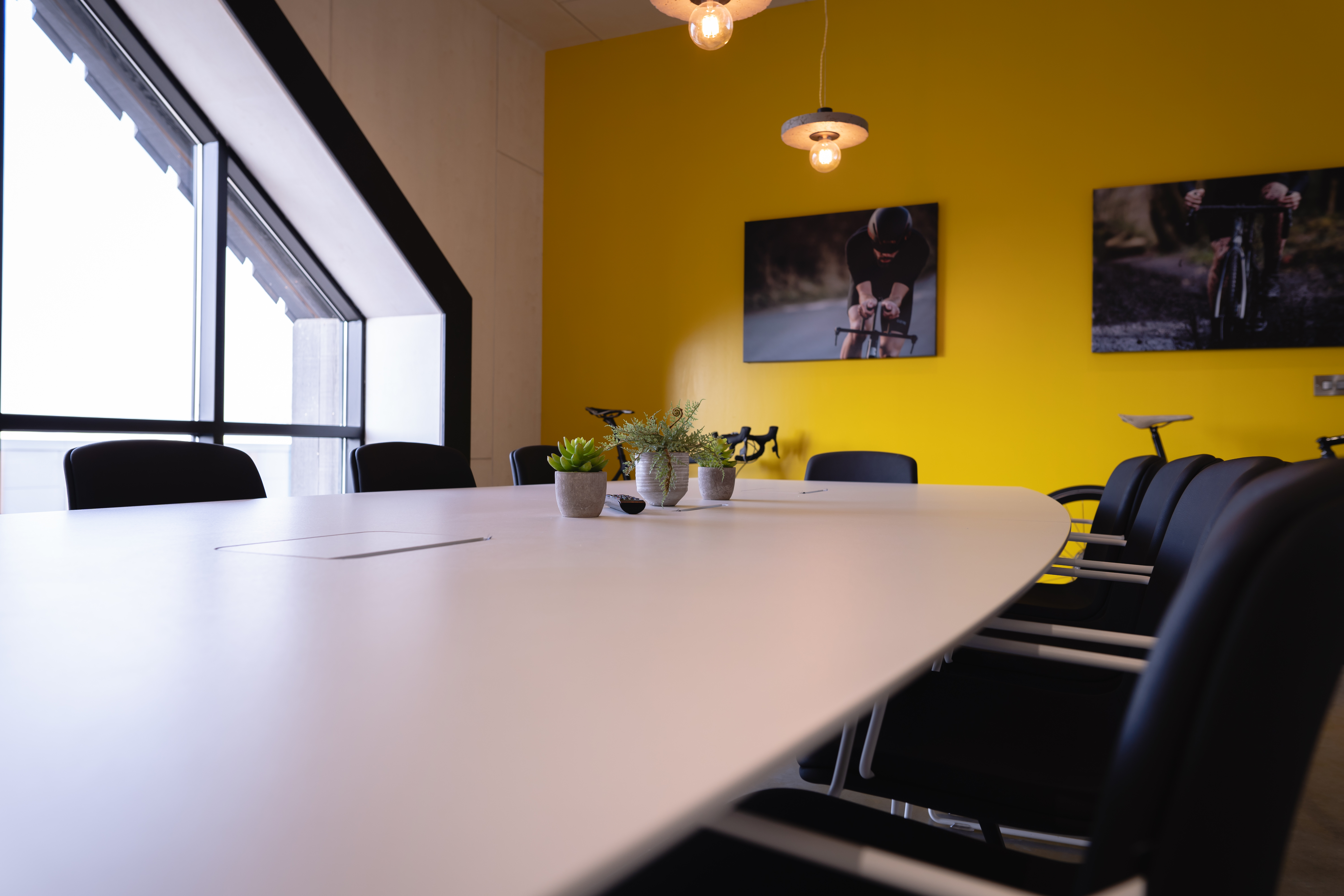 Modern board room with oval table, ideal for meetings and brainstorming events.