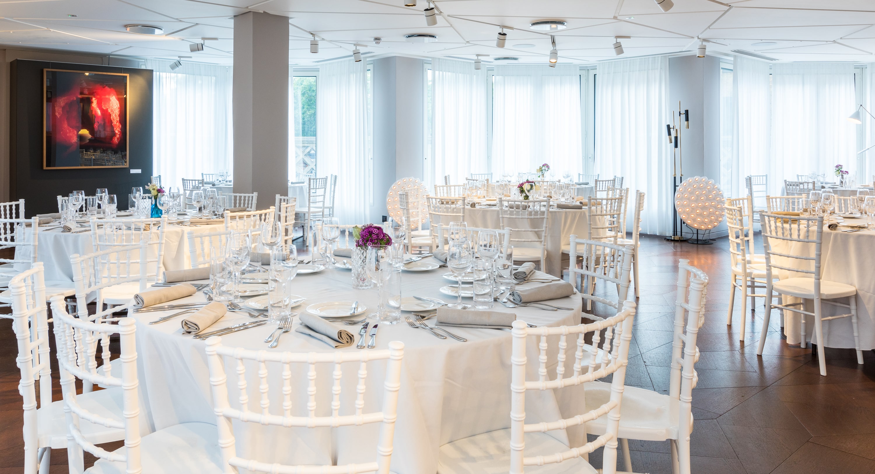 Elegant banquet setting with white chairs at The Lounge, perfect for upscale events.