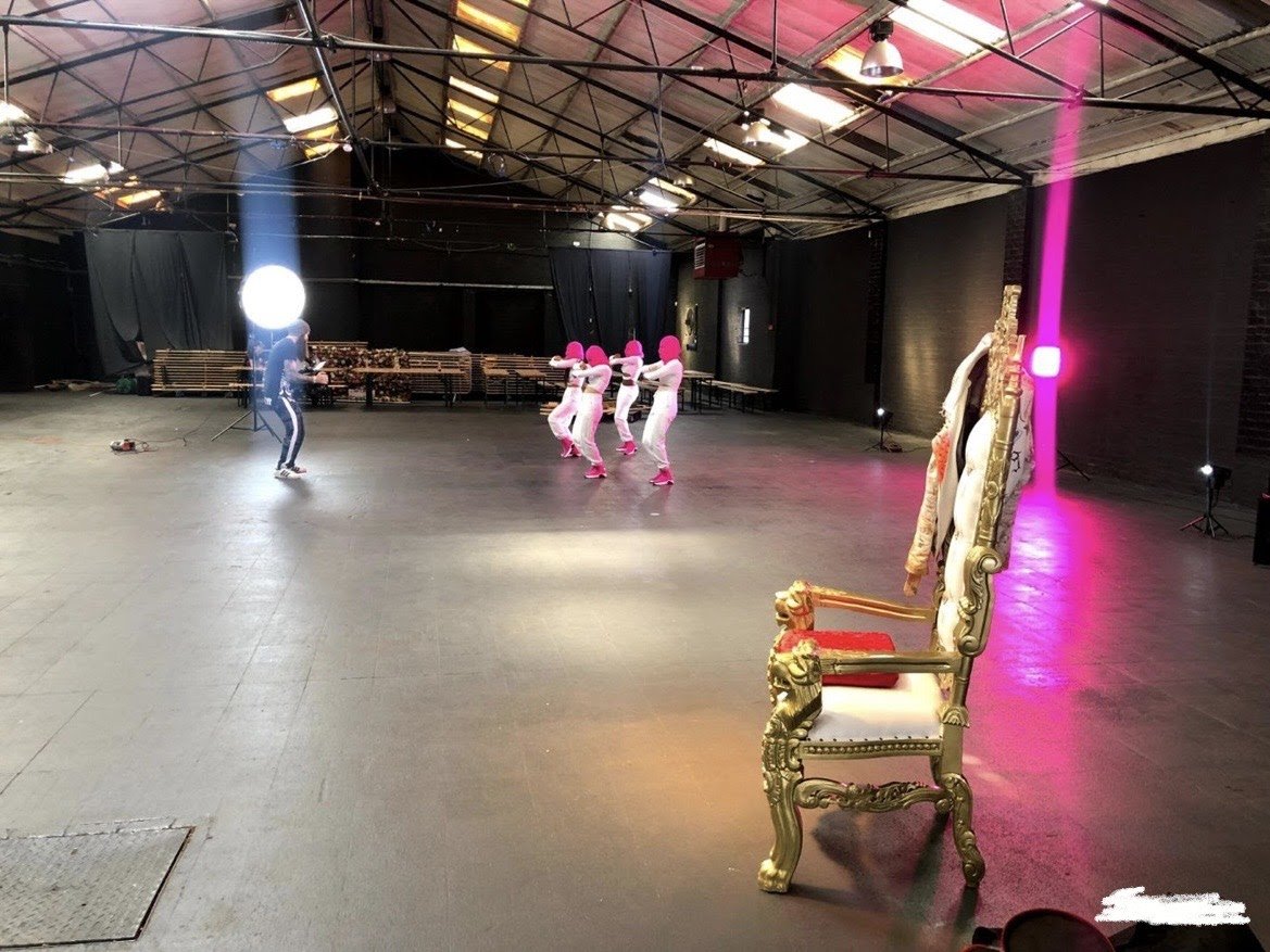 "SS1 event space in Digbeth with vibrant lighting and ornate throne for unique gatherings."