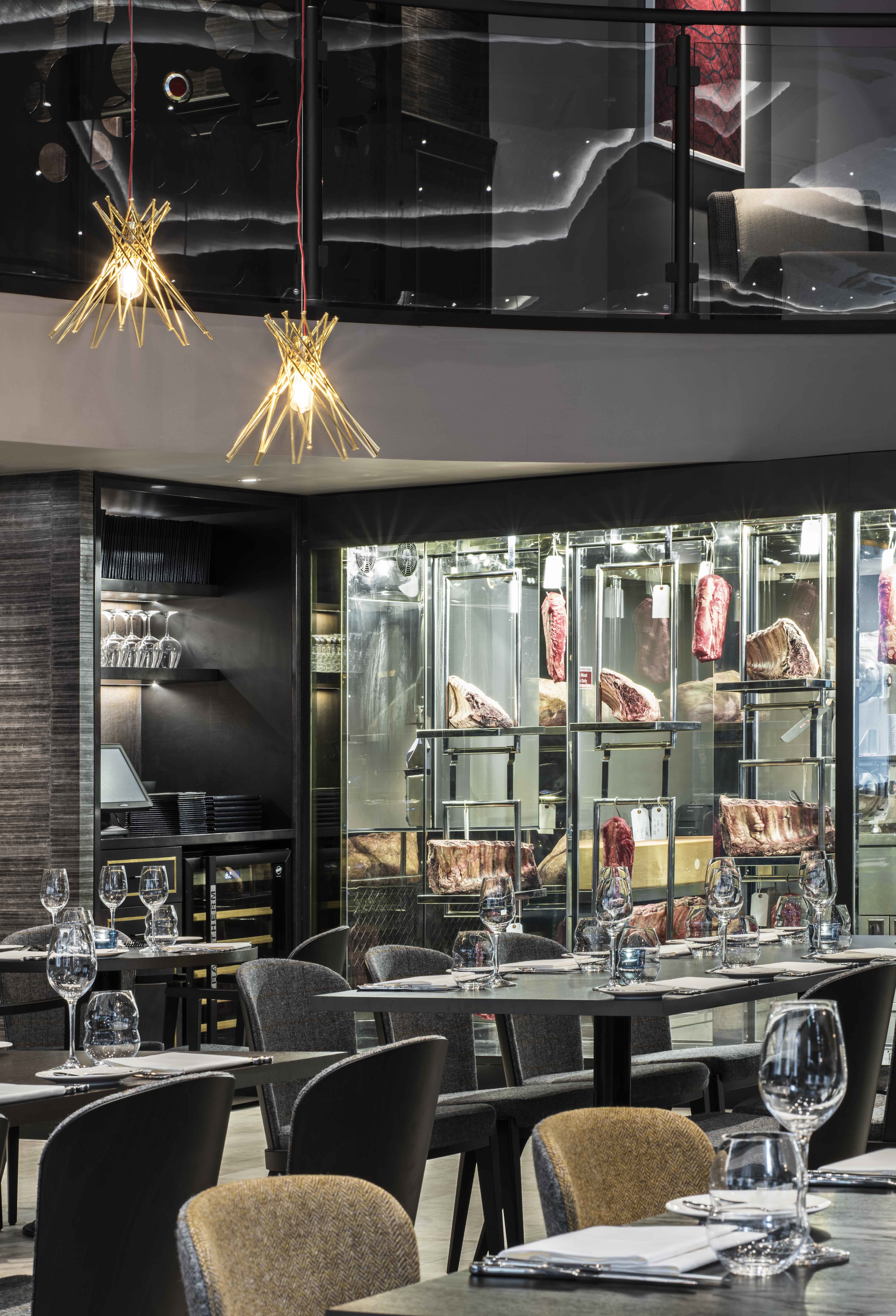 Sophisticated dining space with meat display for upscale corporate events and private gatherings.