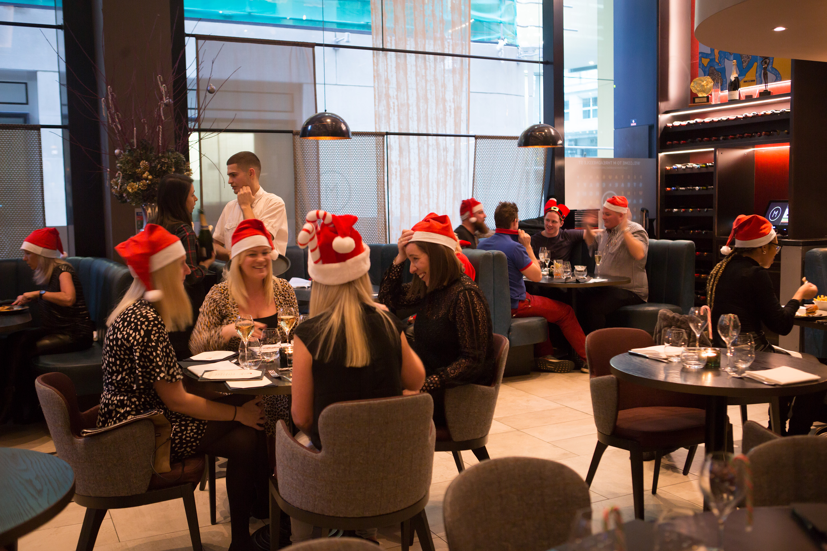 Festive GRILL dining with Santa hats, perfect for holiday corporate events.