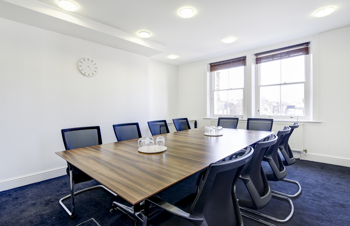 Modern conference room with wooden table, ideal for professional meetings and events.