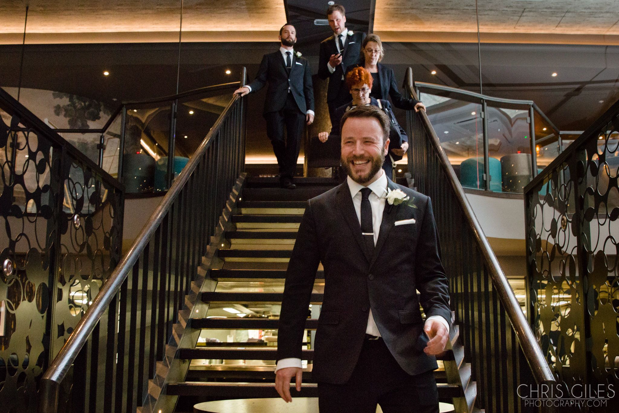 Stylish wedding entrance at M BAR with well-dressed groomsmen and modern decor.