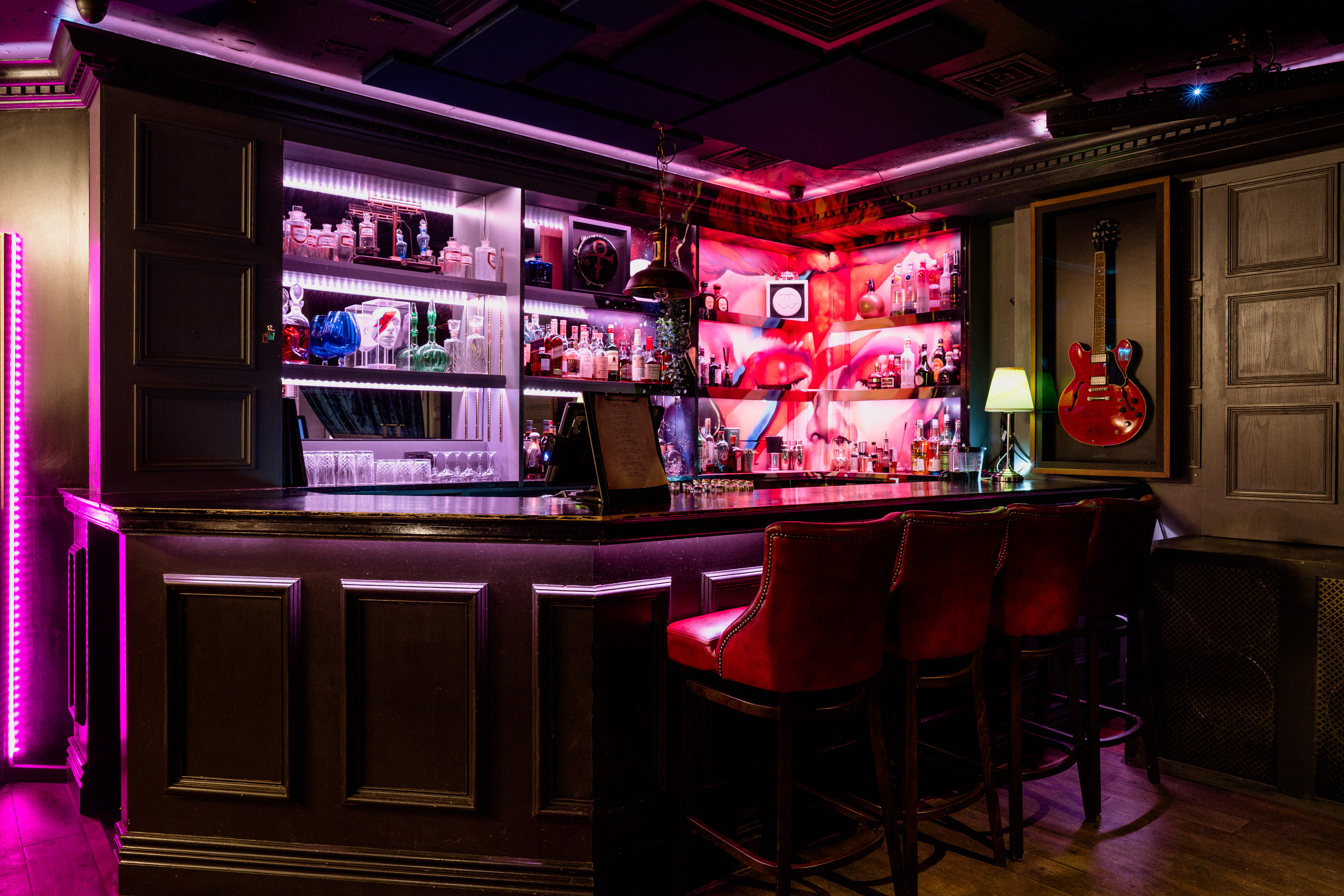 Tape London bar area with vibrant lighting, ideal for networking events and cocktail receptions.